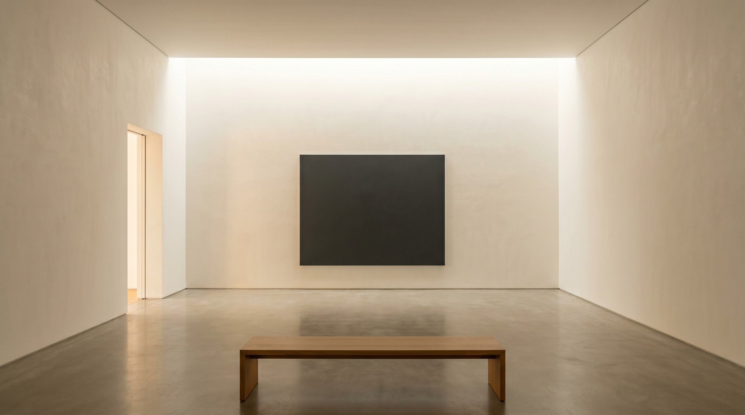 A small contemporary gallery interior — single dark canvas on a back wall, oak bench in foreground, soft light from a continuous skylight slot.